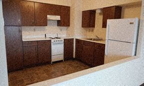 Anoka apartment for rent - Kitchen with dark cupboards and white appliances