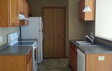 Mankato townhouse for rent - an empty kitchen with a refrigerator and a sink