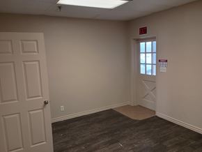 Killeen apartment for rent - A room with a door and a window with a red sign on it.