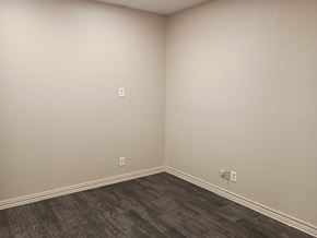 Killeen apartment for rent - A room with a wooden floor and two switches on the wall.