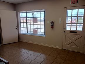 Killeen apartment for rent - A room with a white door, a window, and a fire extinguisher on the wall.