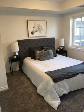Tillsonburg apartment for rent - a bedroom with a bed and a painting of a white horse