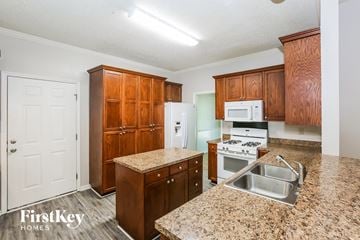 Charlotte house for rent - A kitchen with granite countertops and wooden cabinets.