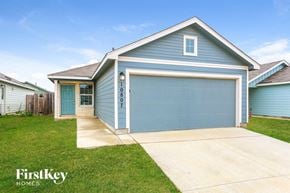 Converse house for rent - A blue house with a garage door numbered 0807.