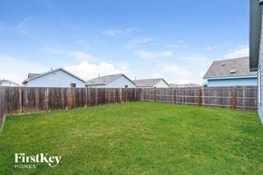 Converse house for rent - A backyard with a wooden fence and a grassy area.