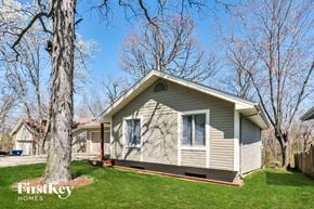 Lake Saint Louis house for rent - A house with a tree in front of it.
