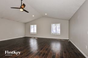 Lake Saint Louis house for rent - A spacious room with wooden floors and two windows.