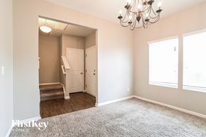 Midland house for rent - a bedroom with a chandelier and a door to a hallway with a door
