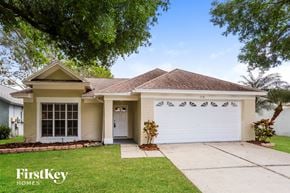 Brandon house for rent - a house with a white garage door and a driveway