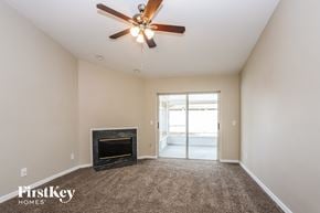 Brandon house for rent - a living room with a fireplace and a ceiling fan