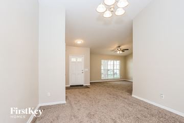 Brandon house for rent - a living room with carpet and a ceiling fan
