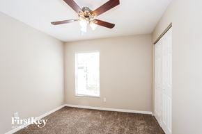Brandon house for rent - a bedroom with a ceiling fan and a window