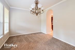 Humble house for rent - a dining room with carpet and a chandelier