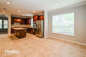 Humble house for rent - a kitchen with stainless steel appliances and a large window