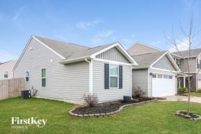 Greenwood house for rent - A house with a grey siding and a white garage door is shown.