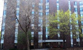 Minneapolis apartment for rent - a tall brick building with trees in front of it