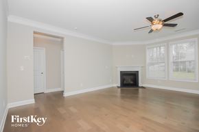 Sherrills Ford house for rent - a living room with a fireplace and a ceiling fan