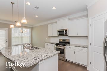 Sherrills Ford house for rent - a white kitchen with granite counter tops and stainless steel appliances
