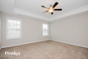 Sherrills Ford house for rent - the master bedroom has a ceiling fan and beige carpet