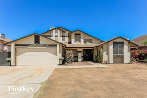 Peoria house for rent - a house with a driveway and a garage door