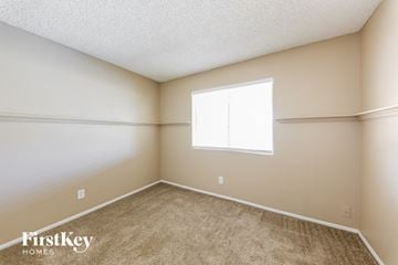 Peoria house for rent - the living room of a home with carpet and a window
