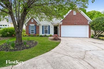 Charlotte house for rent - a house with a white garage door and a driveway
