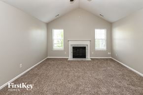 Charlotte house for rent - the living room has a fireplace and carpeted flooring