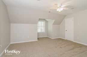 Winston-Salem house for rent - the spacious living room with ceiling fan and carpeting