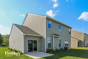 Lexington house for rent - a gray house with a gray roof and a grassy yard