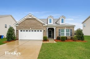 Mooresville house for rent - A house with a garage and a driveway in front of it.
