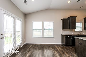Mooresville house for rent - A kitchen with a black counter top and wooden floors.