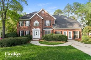 Charlotte house for rent - a brick house with a white front door and a lawn