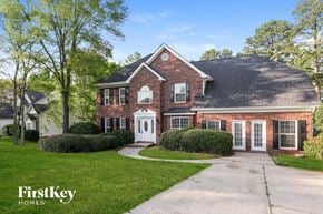 Charlotte house for rent - a brick house with a white front door and a driveway