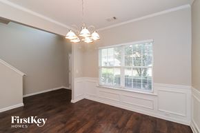 Woodstock house for rent - A well-lit room with wooden floors and a window with blinds.