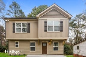 Kannapolis house for rent - A two-story house with a brown door and windows.