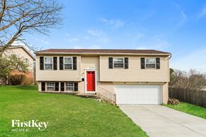 Middletown house for rent - a beige house with a red door and a white garage door