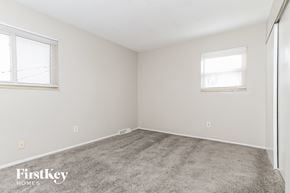 Middletown house for rent - a bedroom with carpet and two windows