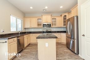 San Tan Valley house for rent - a kitchen with wooden cabinets and stainless steel appliances