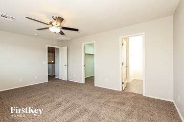 San Tan Valley house for rent - a spacious living room with carpet and a ceiling fan