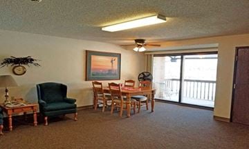 Hawley apartment for rent - A living room with a green chair and a painting on the wall.