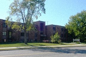 St Cloud apartment for rent - a large brick building with trees in front of it