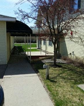 Aitkin apartment for rent - a covered walkway in front of a house