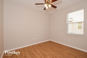Parrish house for rent - the bedroom with wood floors and a ceiling fan