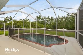 Parrish house for rent - a backyard pool is protected by a glass roof