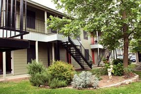 Austin apartment for rent - the front of a house with stairs and a yard with plants