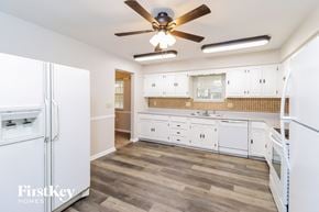 West Chester house for rent - a kitchen with white cabinets and a ceiling fan