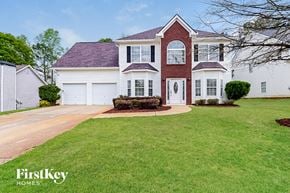 Hampton house for rent - A large house with a red roof and a white garage door.