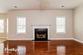 Hampton house for rent - A living room with a fireplace and two windows.