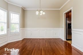 Hampton house for rent - A room with wooden floors and white walls.