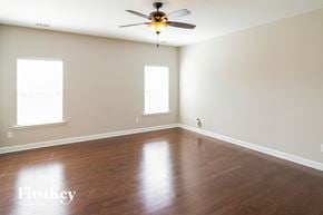 Ladson house for rent - A room with a ceiling fan and two windows.